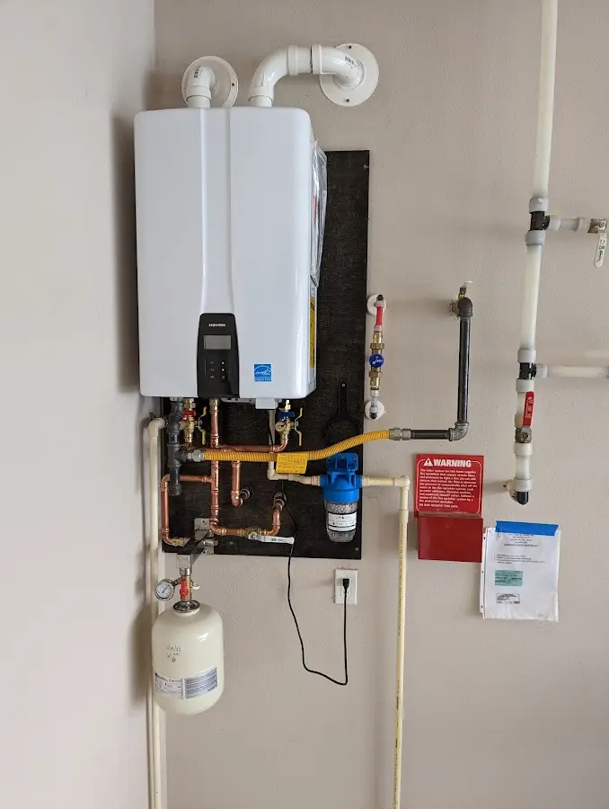 Professional plumber installing copper piping in a Snyderville home